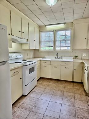 Hattiesburg apartment for rent - A kitchen with white appliances and cabinets.