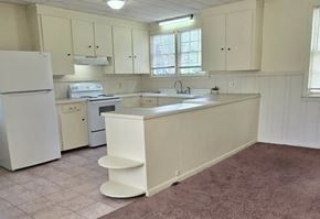 Hattiesburg apartment for rent - A kitchen with white appliances and cabinets.