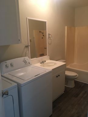 Hattiesburg apartment for rent - A small bathroom with a washer and dryer.