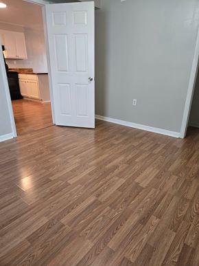 Hattiesburg apartment for rent - A room with a white door and wooden flooring.