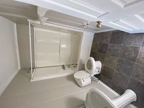 Hattiesburg house for rent - a small bathroom with a toilet and a shower