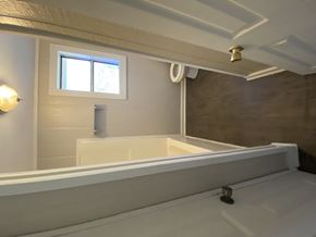Hattiesburg house for rent - a bathroom with a bath tub and a sink and a window
