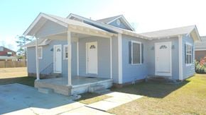 Hattiesburg house for rent - the front of a blue house with a porch