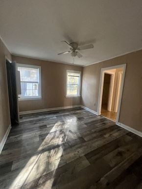 Hattiesburg house for rent - A room with a ceiling fan and a doorway leading to another room.