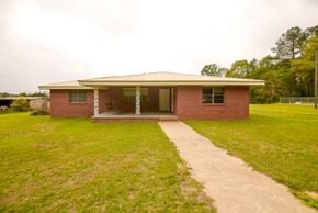 Sumrall house for rent - a small brick house with a walkway in front of it