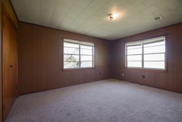 Sumrall house for rent - a living room with a carpeted floor and two windows