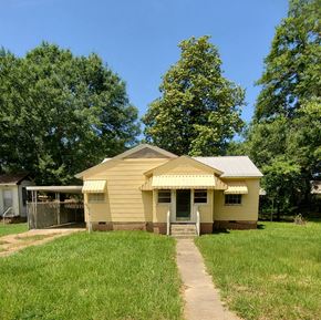 Prentiss house for rent - A small yellow house with a metal roof and a porch.