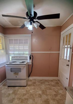 Prentiss house for rent - A room with a fan and a stove.