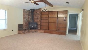 Seminary house for rent - a living room with a fireplace and a book shelf