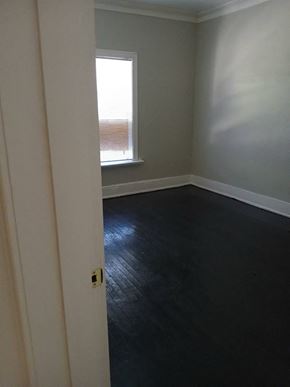 Louisville apartment for rent - an empty room with black flooring and a window