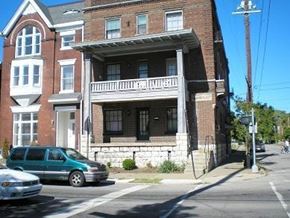 Louisville apartment for rent - a building on the corner of a street with a car