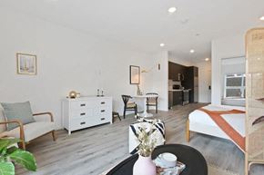 Los Angeles apartment for rent - a bedroom with a bed and a living room with a desk and a kitchen