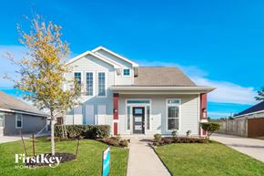 Humble house for rent - A house with a blue and white exterior and a red door is for sale by FirstKey Homes.