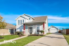 Humble house for rent - A white house with a red door and a sign that says "Firstkey Homes" in front of it.