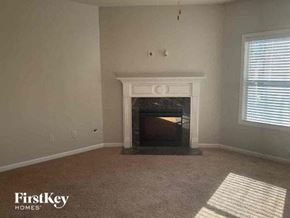 Buford house for rent - A living room with a fireplace and a carpet.