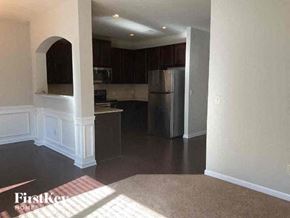 Buford house for rent - A kitchen with a refrigerator, microwave, and oven.