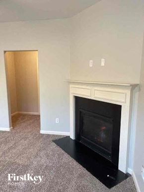 Powder Springs house for rent - an empty living room with a fireplace