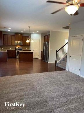 Powder Springs house for rent - a living room with a kitchen and a staircase
