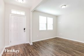 Jacksonville house for rent - A room with a white door and wooden flooring.
