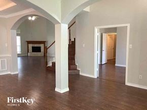 Mansfield house for rent - an empty living room with a hard wood floor and a staircase