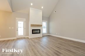 Clarksville house for rent - A spacious room with a fireplace and a door leading to a balcony.