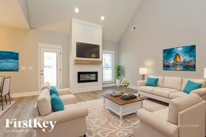 Clarksville house for rent - A living room with a fireplace and a painting on the wall.