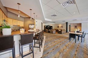 Minneapolis apartment for rent - A dining area with a bar, tables, and chairs.