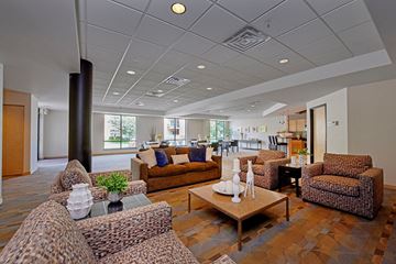 Minneapolis apartment for rent - A living room with brown furniture and a wooden floor.