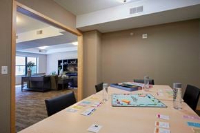 Minneapolis apartment for rent - A conference room with a long table with a board game on it.