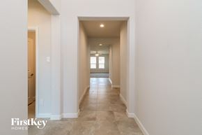 Waxahachie house for rent - A long hallway with a light at the end.