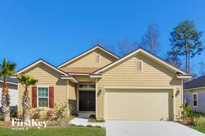 Jacksonville house for rent - a tan house with a garage door