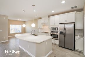 Jacksonville house for rent - a large white kitchen with stainless steel appliances and white counter tops