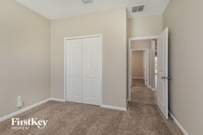 Jacksonville house for rent - a bedroom with two closets and a door to a hallway