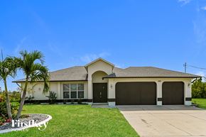 Cape Coral house for rent - a house with a palm tree in front of it