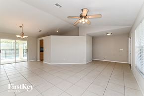 Cape Coral house for rent - an empty living room with a ceiling fan