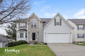 Charlotte house for rent - a white house with white siding and a white garage door