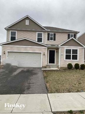 Blacklick house for rent - a beige house with a white garage door