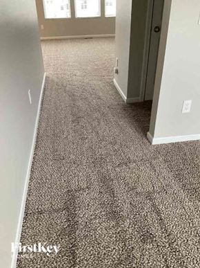 Blacklick house for rent - a gray carpeted floor in a room with an open door