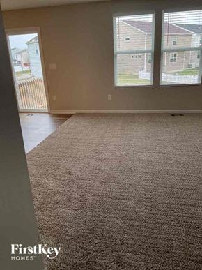 Blacklick house for rent - an empty living room with a rug in front of a window