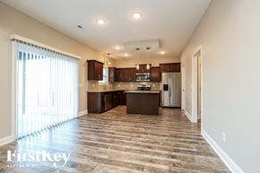 Clarksville house for rent - A spacious kitchen with wooden flooring and a large island.