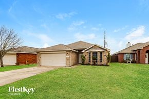 Baytown house for rent - A house with a brown roof and a white garage door is for sale.