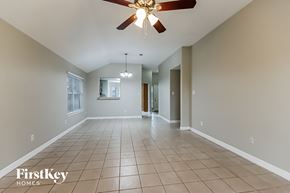 Baytown house for rent - A spacious room with a fan and tiled flooring.