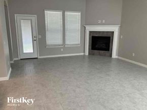 Haslet house for rent - A room with a fireplace and a door.