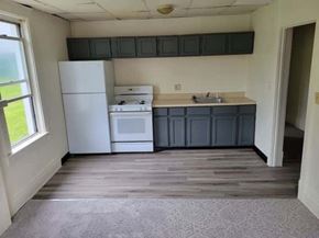 Homestead apartment for rent - A kitchen with white appliances and a window.
