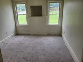 Homestead apartment for rent - A room with a carpet floor and a window.