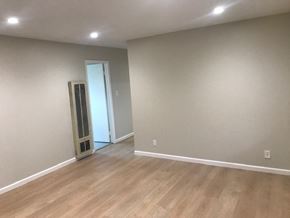 Oakland apartment for rent - A room with a wooden floor and a white door.
