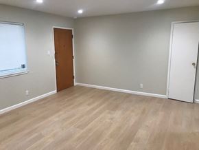 Oakland apartment for rent - A room with a wooden floor and two doors.