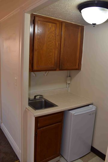 Louisville apartment for rent - A small kitchen with a sink and a dishwasher.