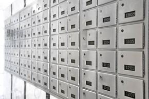 Montréal apartment for rent - A wall of mailboxes with numbers ranging from 1009 to 1207.