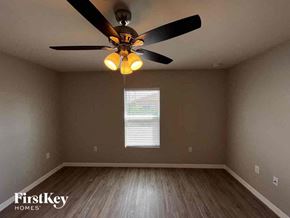 Cape Coral house for rent - a bedroom with a ceiling fan and a window